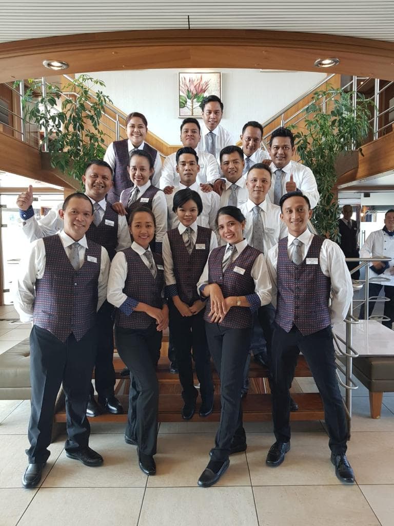 Indonesian hospitality crew members together onboard a vessel